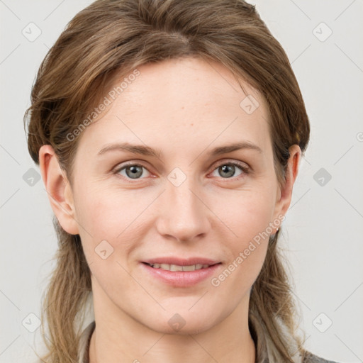 Joyful white young-adult female with long  brown hair and blue eyes