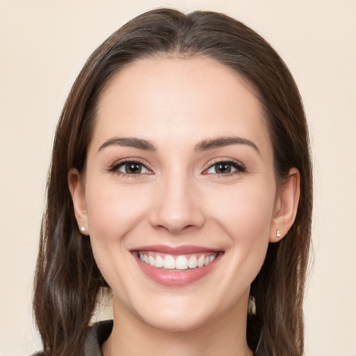 Joyful white young-adult female with long  brown hair and brown eyes