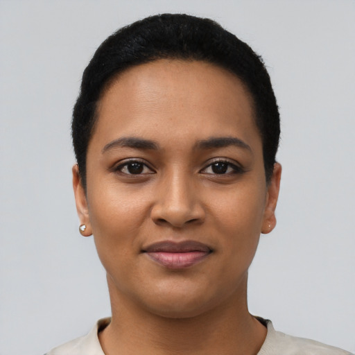 Joyful latino young-adult female with short  black hair and brown eyes