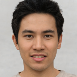 Joyful asian young-adult male with short  black hair and brown eyes