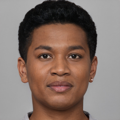 Joyful black young-adult male with short  black hair and brown eyes