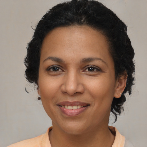 Joyful latino young-adult female with short  brown hair and brown eyes