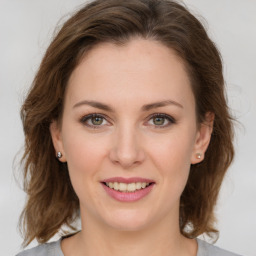 Joyful white young-adult female with medium  brown hair and green eyes