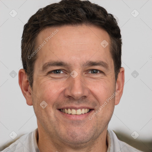 Joyful white adult male with short  brown hair and brown eyes