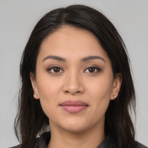 Joyful latino young-adult female with long  brown hair and brown eyes
