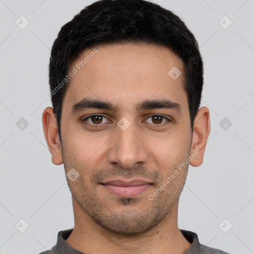 Joyful latino young-adult male with short  black hair and brown eyes