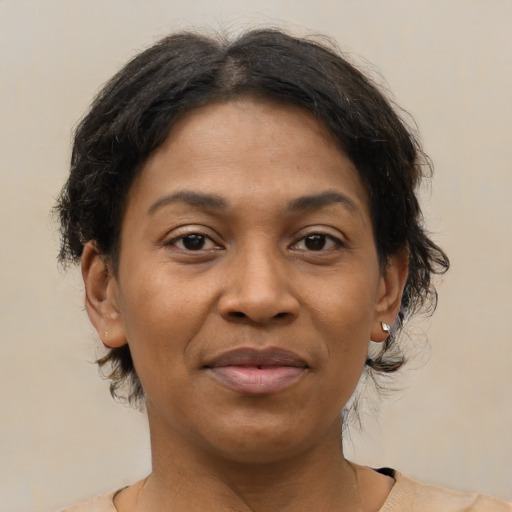 Joyful black adult female with medium  brown hair and brown eyes