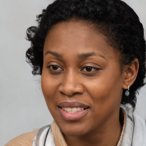 Joyful black young-adult female with short  brown hair and brown eyes