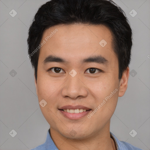 Joyful asian young-adult male with short  black hair and brown eyes