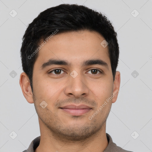 Joyful latino young-adult male with short  brown hair and brown eyes