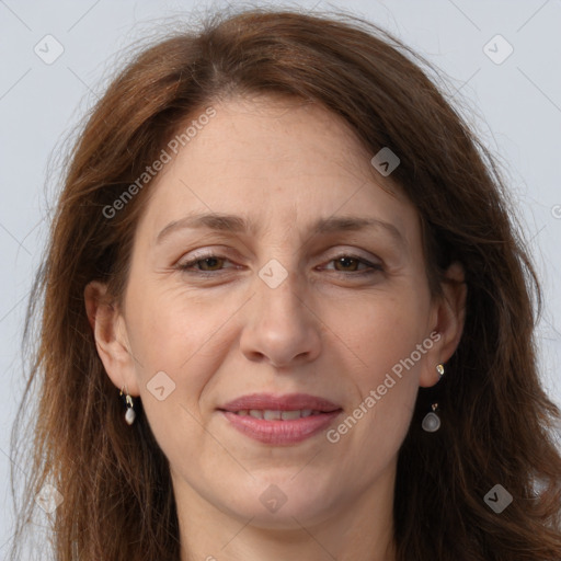 Joyful white adult female with long  brown hair and grey eyes