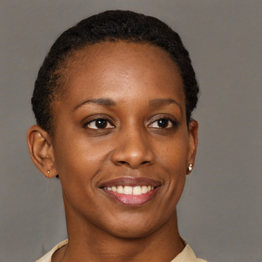 Joyful black young-adult female with short  brown hair and brown eyes