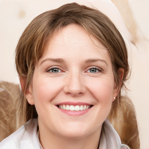 Joyful white young-adult female with medium  brown hair and blue eyes