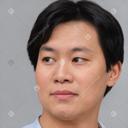 Joyful asian young-adult male with short  black hair and brown eyes