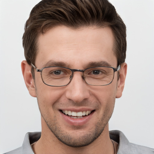 Joyful white young-adult male with short  brown hair and grey eyes