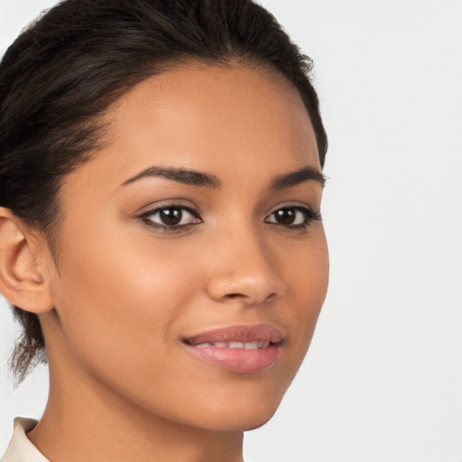 Joyful latino young-adult female with medium  brown hair and brown eyes