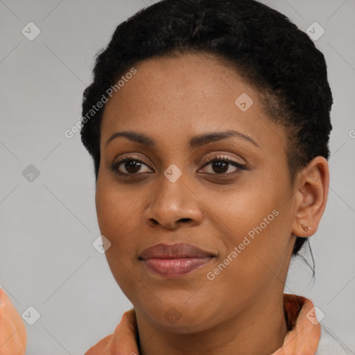 Joyful black young-adult female with short  black hair and brown eyes