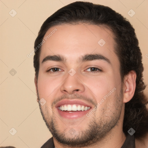 Joyful white young-adult male with short  black hair and brown eyes