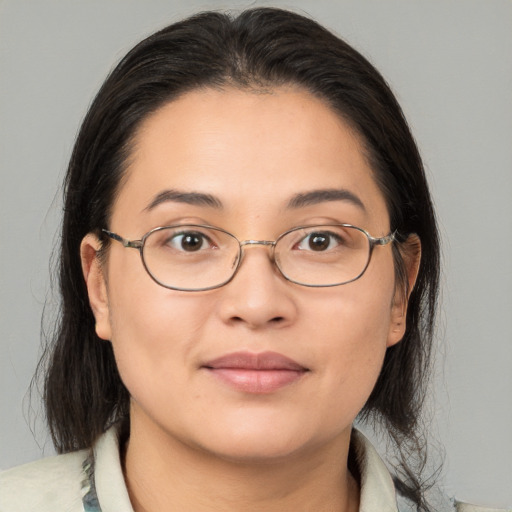 Joyful white adult female with medium  brown hair and brown eyes