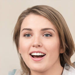 Joyful white young-adult female with medium  brown hair and green eyes