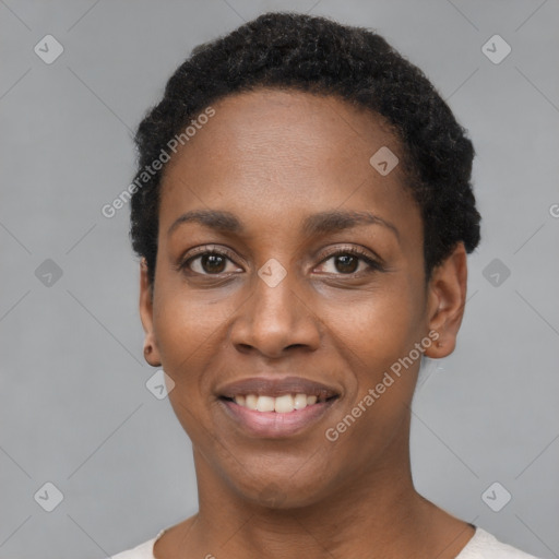 Joyful black young-adult female with short  black hair and brown eyes