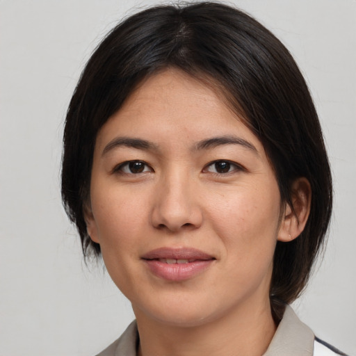 Joyful asian young-adult female with medium  brown hair and brown eyes