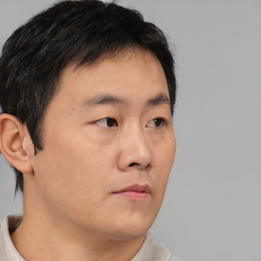 Neutral asian young-adult male with short  brown hair and brown eyes