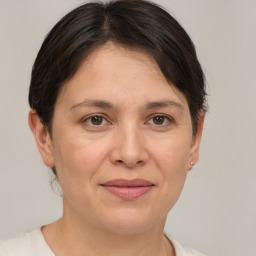 Joyful white adult female with short  brown hair and brown eyes