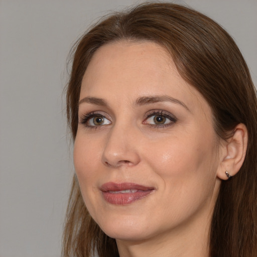 Joyful white adult female with long  brown hair and brown eyes