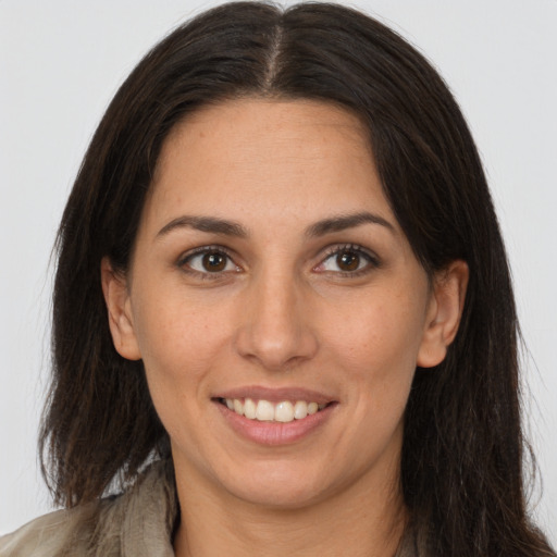 Joyful white young-adult female with long  brown hair and brown eyes