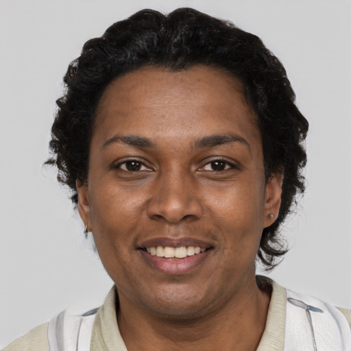 Joyful black adult female with short  brown hair and brown eyes