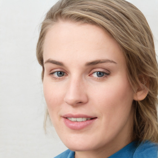 Joyful white young-adult female with medium  brown hair and blue eyes