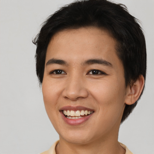 Joyful asian young-adult female with short  brown hair and brown eyes