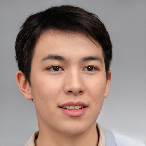 Joyful asian young-adult male with short  brown hair and brown eyes