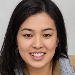 Joyful asian young-adult female with long  brown hair and brown eyes