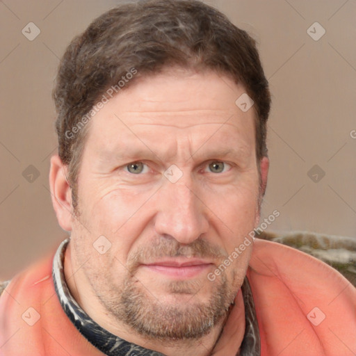 Joyful white adult male with short  brown hair and grey eyes