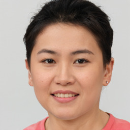 Joyful asian young-adult female with short  brown hair and brown eyes