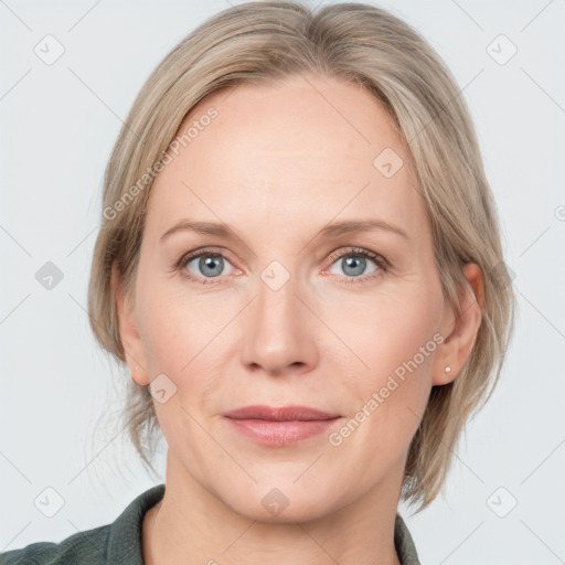 Joyful white adult female with medium  brown hair and blue eyes