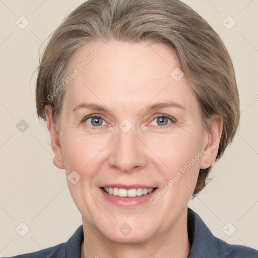 Joyful white adult female with medium  brown hair and grey eyes