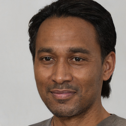 Joyful latino adult male with short  black hair and brown eyes