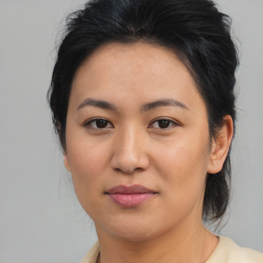 Joyful asian young-adult female with medium  brown hair and brown eyes