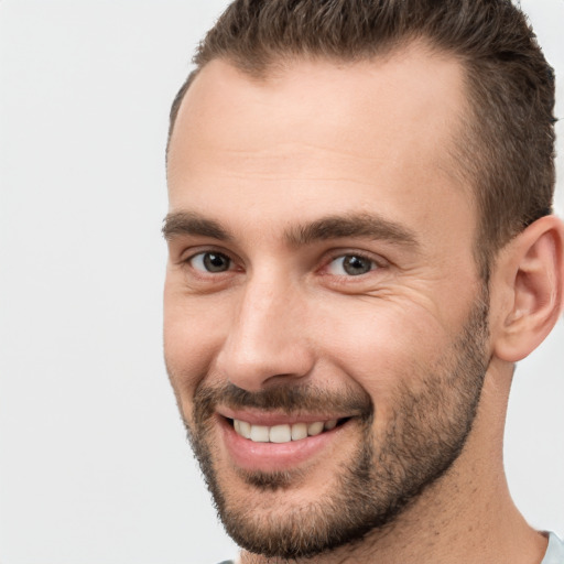 Joyful white young-adult male with short  brown hair and brown eyes