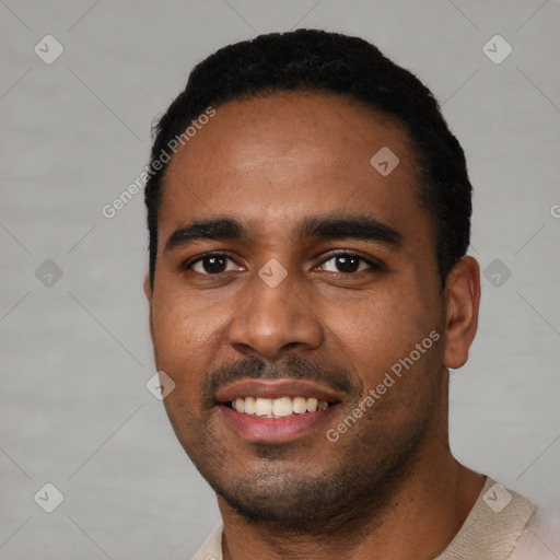 Joyful black young-adult male with short  black hair and brown eyes