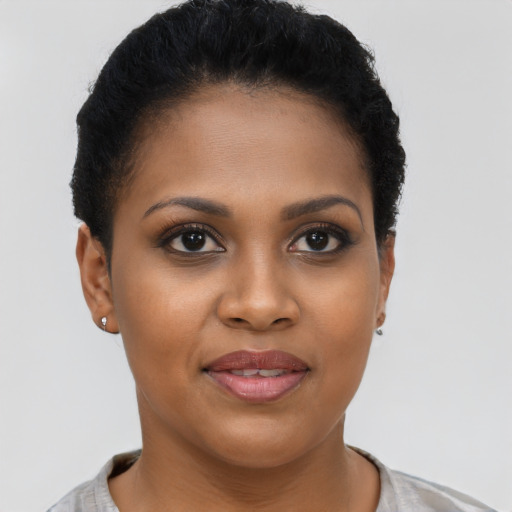 Joyful black young-adult female with short  brown hair and brown eyes