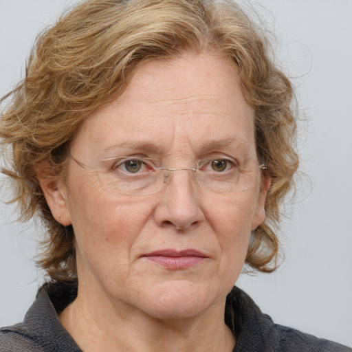 Joyful white middle-aged female with medium  brown hair and blue eyes