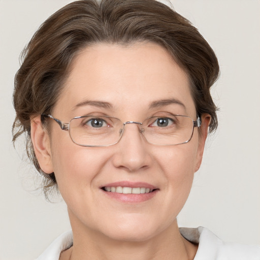 Joyful white adult female with medium  brown hair and grey eyes