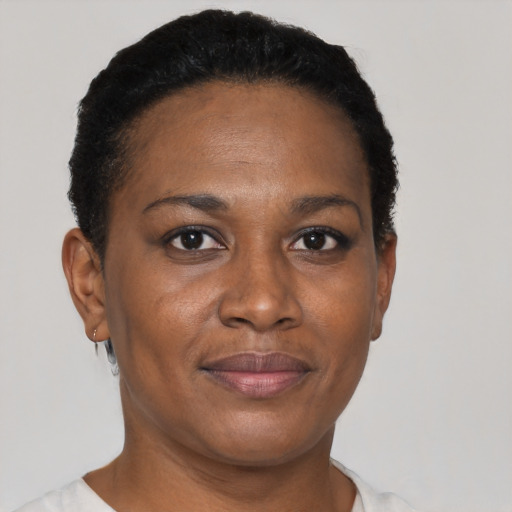 Joyful black adult female with short  black hair and brown eyes