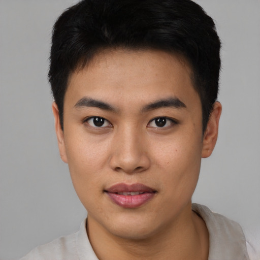 Joyful asian young-adult male with short  black hair and brown eyes