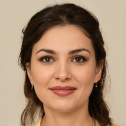 Joyful white young-adult female with medium  brown hair and brown eyes