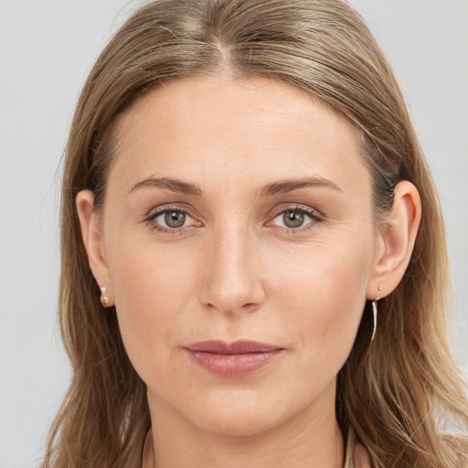 Joyful white young-adult female with long  brown hair and blue eyes